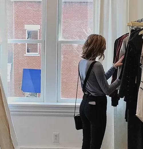 Woman browsing clothing rack